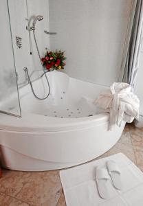 a bathroom with a bath tub with a bow on it at Hotel Contà Taste The Experience in Pieve di Soligo