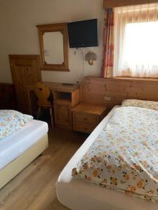 Postel nebo postele na pokoji v ubytování Garni Cristallo