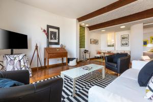 a living room with a couch and a table at Lovely New Attic, Piazza del Popolo! in Rome