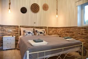 a bedroom with a large bed in a room at Kampos Family Garden in Batsi +20 photos
