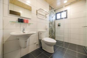a bathroom with a toilet and a sink at 澎湖海景民宿 島嶼時光 Island Time Homestay in Magong