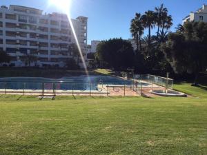 a fountain in a park with a soccer field at Large and elegant in Puerto Banus with pools and paddle in Marbella