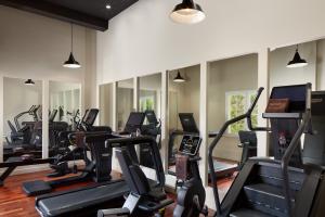 a gym with many treadmills and elliptical machines at Le Grand Hôtel Le Touquet-Paris-Plage in Le Touquet-Paris-Plage