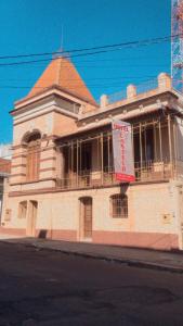 a building with a banner in front of it at Hotel Castelo in Santana do Livramento