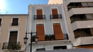 a building with balconies on the side of it at Blaucel Cafè i Habitacions in Cullera