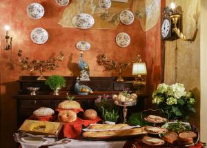 
a table topped with plates of food and flowers at Hotel Gabbia D'Oro in Verona
