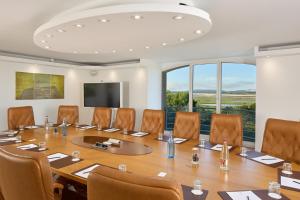 a conference room with a large table and chairs at Le Grand Hôtel Le Touquet-Paris-Plage in Le Touquet-Paris-Plage