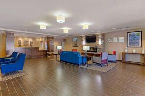 a lobby of a hospital with blue chairs and a table at Comfort Inn & Suites Lynchburg Airport - University Area in Lynchburg