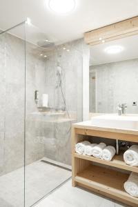 a bathroom with a sink and a shower at Chalet familial Fleurs des Bois - Rochebrune in Megève