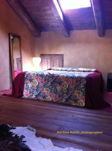 A bed or beds in a room at La Corte del Barbio