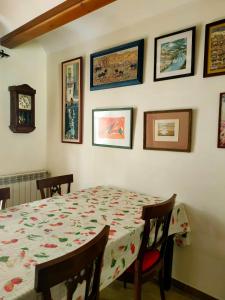 a dining room with a table and some pictures on the wall at Ca la Magda in Camarasa