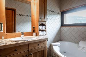 a bathroom with a sink and a bath tub at Chalet familial Fleurs des Bois - Rochebrune in Megève +37 photos