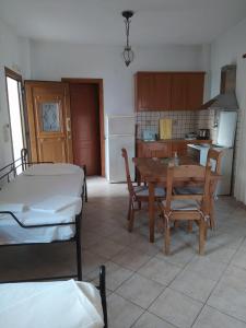 a kitchen with a table and a dining room with a table and chairs at Villa Avli in Parga +23 photos