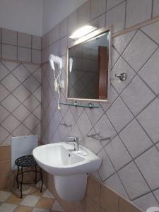 a bathroom with a sink and a mirror at Villa Avli in Parga
