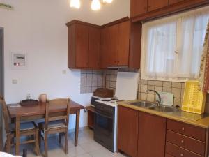 a kitchen with a table and a stove and a sink at Villa Avli in Parga