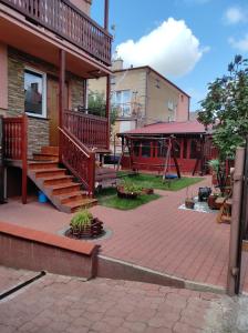 a house with a staircase and a playground at Hostel Texas in Suwałki