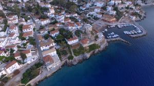 an aerial view of a town with boats in the water at Options House in Hydra