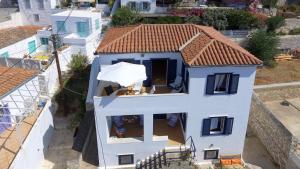 an aerial view of a white house with a red roof at Options House in Hydra