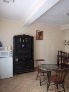 a kitchen with a table and chairs and a refrigerator at Maydã in Praia Grande +33 photos