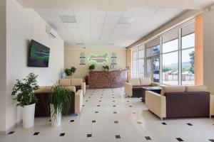 an empty waiting room with couches and plants at Business Hotel Rodina in Essentuki