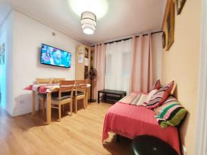 a living room with a table and a dining room at HomeStay Olivos in Madrid