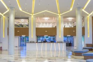 a lobby with a bar in the middle of a building at Lyttos Mare in Hersonissos