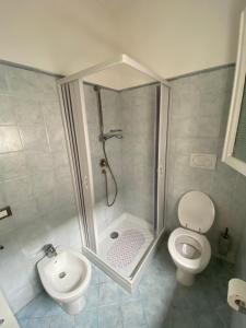 a bathroom with a shower and a toilet at La casa del pescatore in Viareggio
