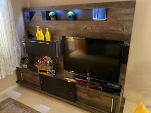 a flat screen tv sitting on a entertainment center at Cantinho do Cônego in Nova Friburgo