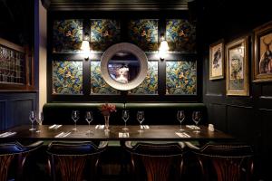 a dining room with a table and a mirror at Caledonian Hotel in Newcastle upon Tyne