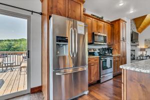 a stainless steel refrigerator in a kitchen with a deck at Rockwood Lake Lodge home in Branson