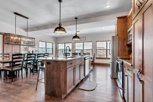 a kitchen with a large island and a dining room at Rockwood Lake Lodge home in Branson