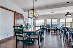 a dining room with a long table and chairs at Rockwood Lake Lodge home in Branson