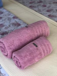 a pair of pink mittens sitting on a bed at Paralia Platanou seaview house in Paralía Platánou