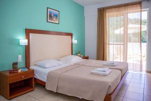 a hotel room with two beds and a window at Xidas Garden in Bali +37 photos
