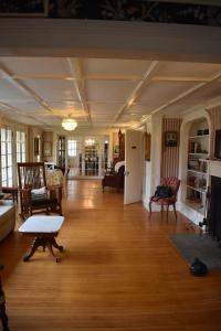 a living room with wood floors and a room with a table at Harbour House Inn B&B in Cheshire
