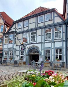 a blue and white building with tables and chairs at Hotel zur Krone in Hameln