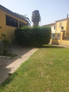 a hedge in front of a house with a building at Condominio Flabelli in Baratti