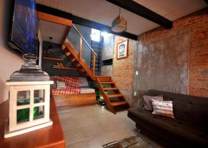 a living room with a couch and a staircase at Pura vida in Chuy