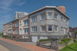 un gran edificio de apartamentos en una calle de la ciudad en Vakantiewoning voor 12 met garages terras tuin en Blankenberge