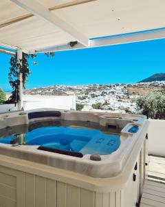 uma banheira de hidromassagem numa varanda com vista em Petali Village Hotel em Apollonia