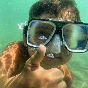 a person with goggles is taking a picture in the water at Emko Apartmens Vir in Vir +12 photos