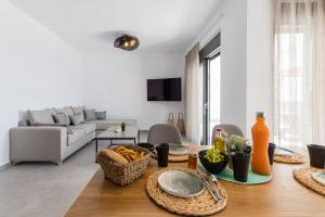 a living room with a table with food on it at Grand Blue Villas Lachania in Lachania