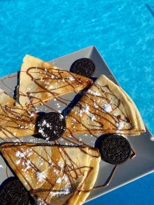 a plate of cookies andocolate oreos next to a pool at Villa Athina in Ambrami