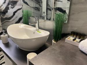 a bathroom with a white bowl sink on a counter at Ninemia luxury apartments in Xylokastron +114 photos