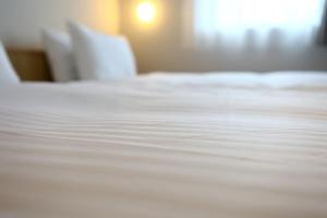 Postel nebo postele na pokoji v ubytování MUSTARD HOTEL SHIMOKITAZAWA