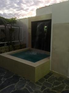 a jacuzzi tub in a building with a fireplace at Casa Bella-suit in Ciudadela Costa de Oro