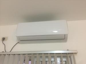 a white air conditioner on the ceiling of a room at Casa Bella-suit in Ciudadela Costa de Oro