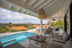 Villa con piscina y sala de estar. en Blue Bay Exclusive - 66, en Dorp Sint Michiel