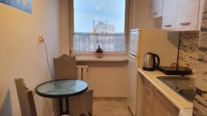 a small kitchen with a table and a window at Apartament Anielki in Malbork