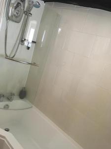 a shower in a bathroom with a white tub at Sweetbriar Cottage Bed & Breakfast and Camping in Starbotton +46 photos